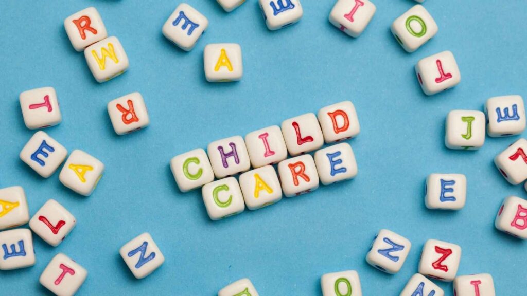 Letter blocks spelling child care on a blue background.