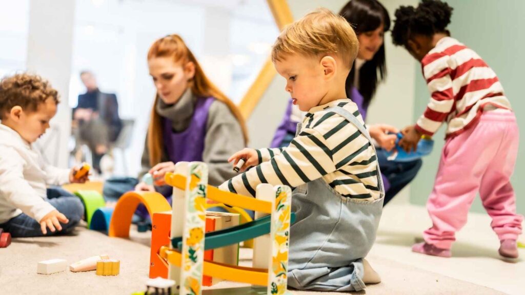 Young children playing with toys during a supervised early childhood classroom activity.